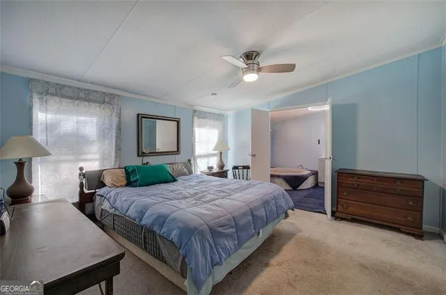 a spacious bedroom with a bed and a chandelier