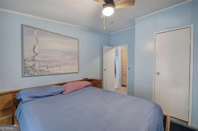 a bedroom with a bed and a painting on the wall