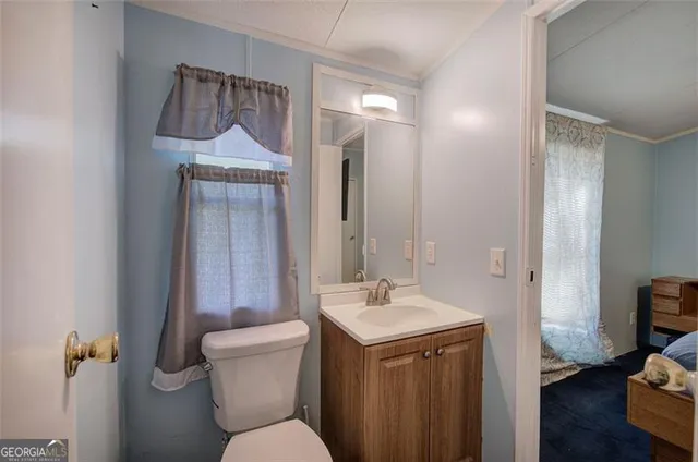 a bathroom with a toilet sink and mirror