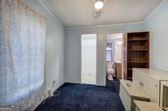 a view of empty room with a window and cabinet