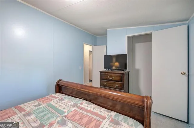 a bedroom with a bed and a television