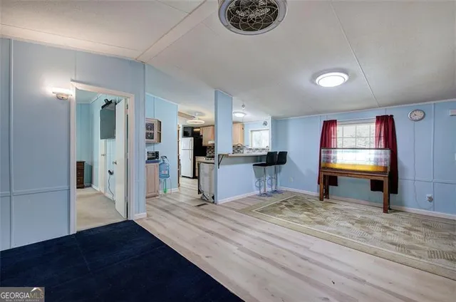 a view of a kitchen with refrigerator stove and wooden floor
