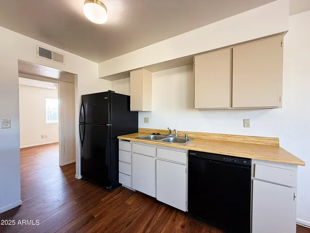 a kitchen with a refrigerator and a sink