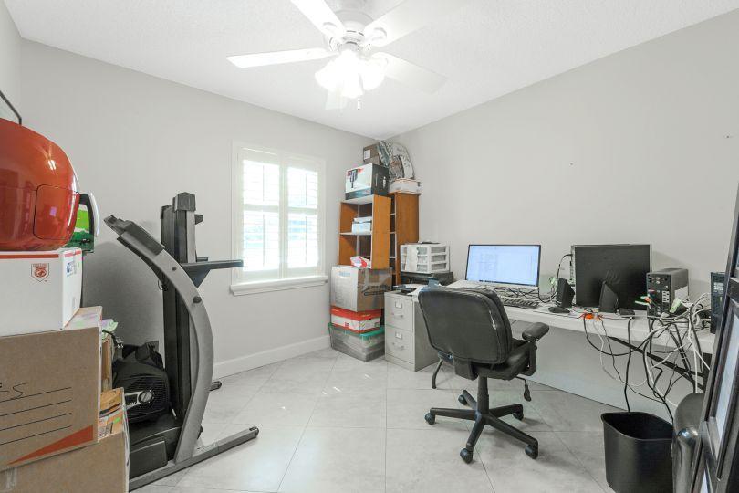 5547 3rd Road Lake Worth, FL 33467 - Photo 19 of 34 a view of a workspace with furniture and a window