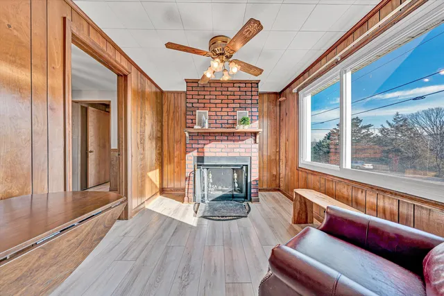 a living room with furniture fireplace and flat screen tv