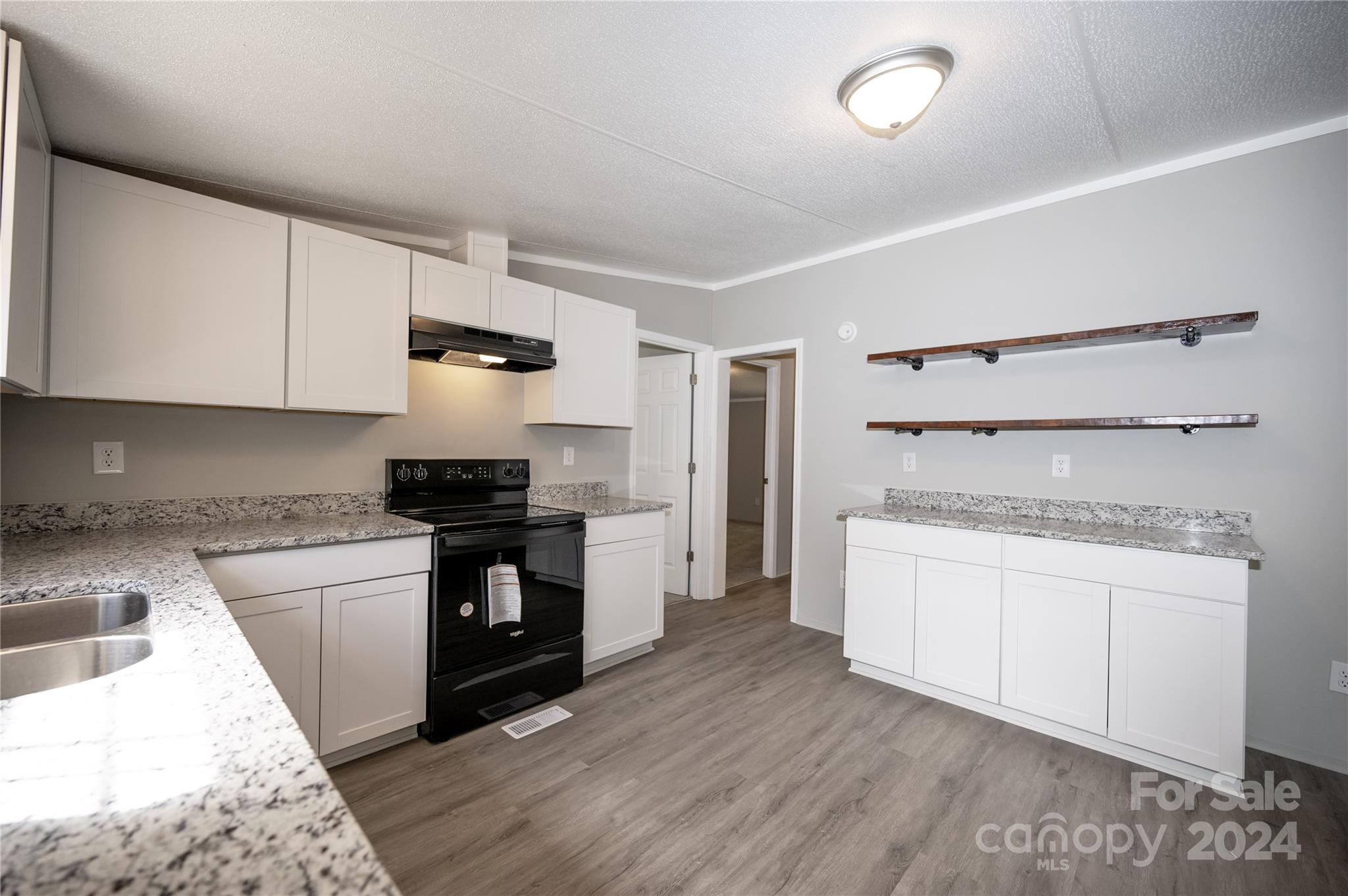 2574 Orchard Road Smyrna, SC 29743 - Photo 7 of 17 a kitchen with a stove and a refrigerator
