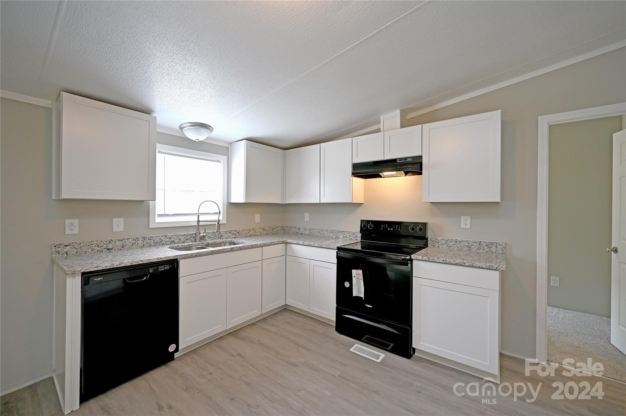 2574 Orchard Road Smyrna, SC 29743 - Photo 8 of 17 a kitchen with stainless steel appliances granite countertop a stove and a sink