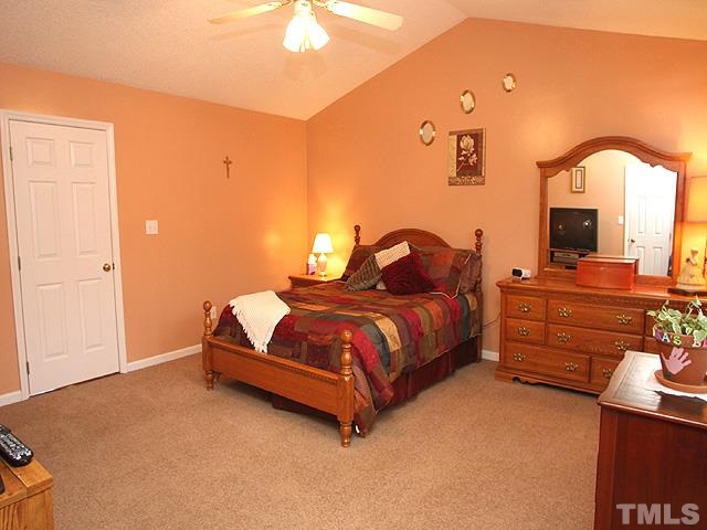 1017 Holland Ridge Drive Raleigh, NC 27603 - Photo 13 of 24 a bedroom with a bed and a flat screen tv