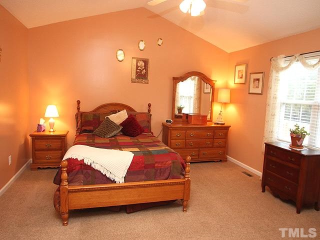 1017 Holland Ridge Drive Raleigh, NC 27603 - Photo 14 of 24 a bedroom with a bed and window