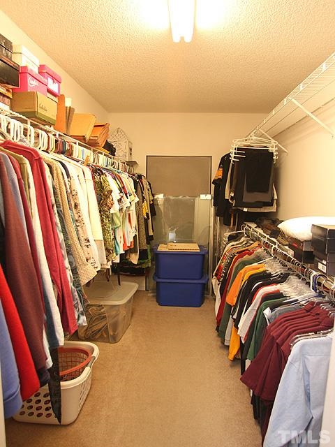 1017 Holland Ridge Drive Raleigh, NC 27603 - Photo 15 of 24 a view of walk in closet with clothes and shoes