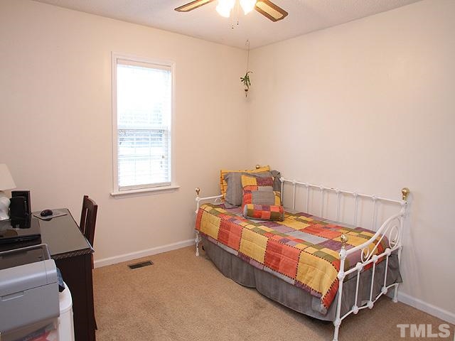 1017 Holland Ridge Drive Raleigh, NC 27603 - Photo 18 of 24 a bedroom with a bed and a window
