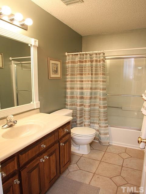 1017 Holland Ridge Drive Raleigh, NC 27603 - Photo 19 of 24 a bathroom with a sink a toilet and shower