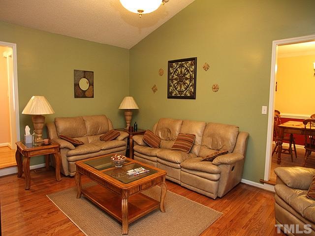 1017 Holland Ridge Drive Raleigh, NC 27603 - Photo 6 of 24 a living room with furniture a lamp and a window