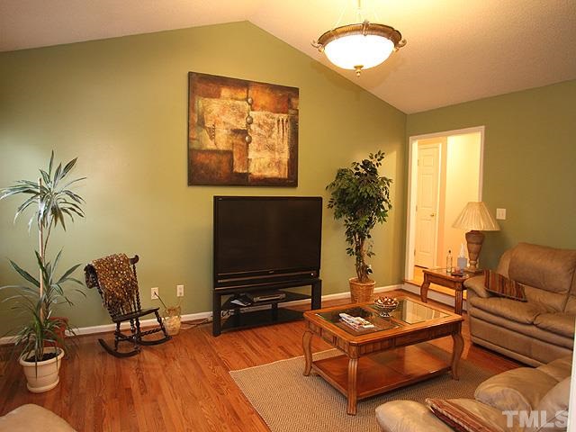 1017 Holland Ridge Drive Raleigh, NC 27603 - Photo 7 of 24 a living room with furniture and a flat screen tv