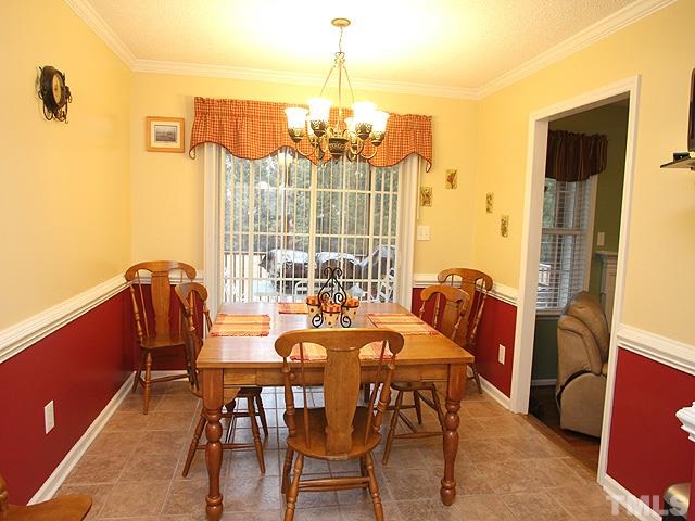 1017 Holland Ridge Drive Raleigh, NC 27603 - Photo 8 of 24 a view of a dining room with furniture window and outside view
