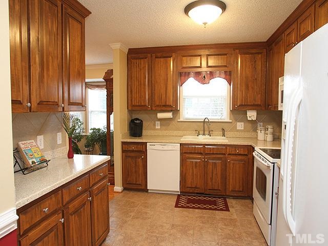 1017 Holland Ridge Drive Raleigh, NC 27603 - Photo 9 of 24 a kitchen with a sink stove and refrigerator