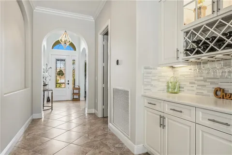 a view of a hallway with fireplace and wooden floor