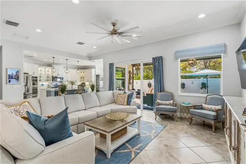 a living room with furniture and a view of kitchen