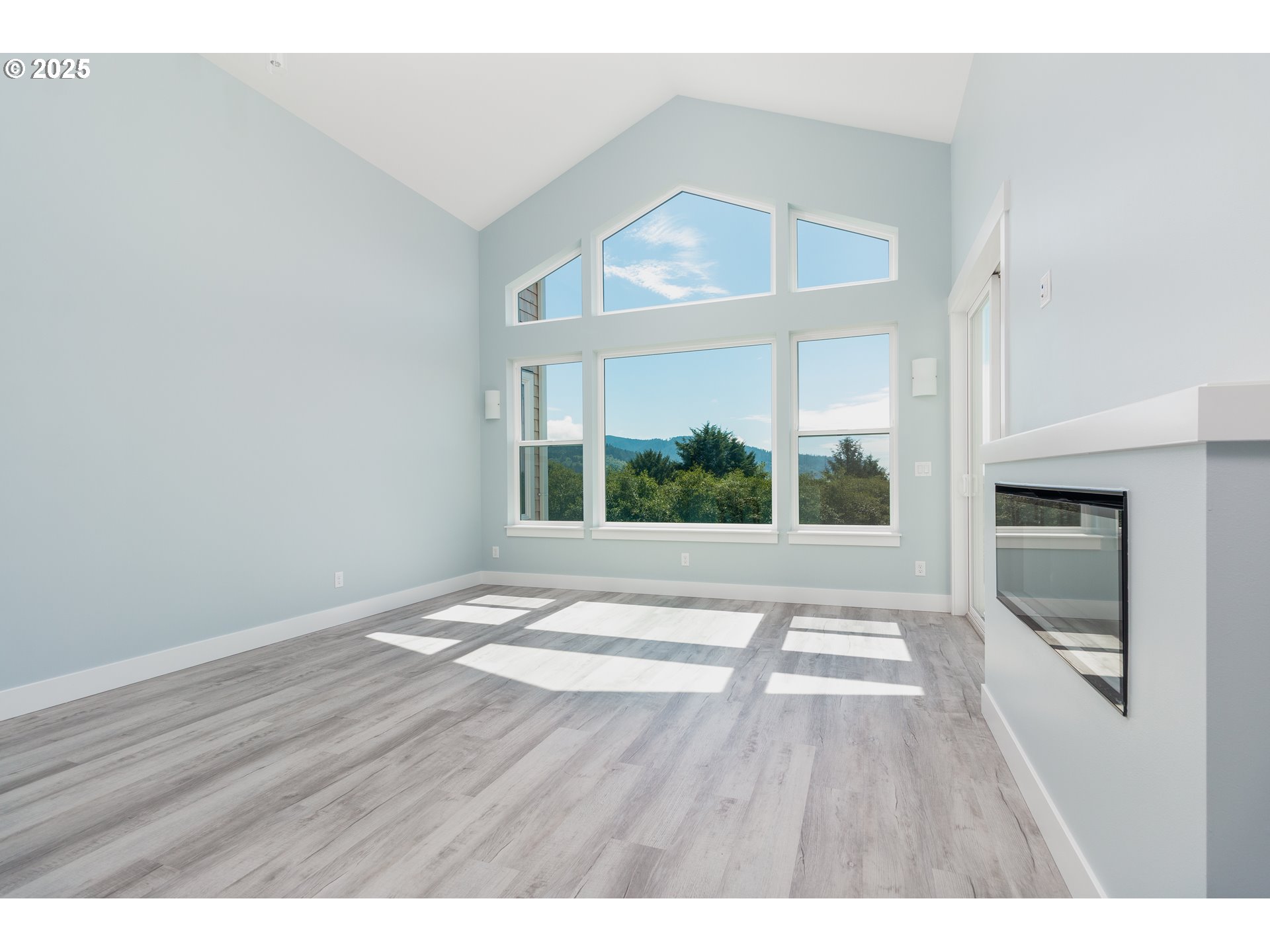 6485 Heron View Neskowin, OR 97149 - Photo 41 of 46 a view of an empty room with a window and wooden floor