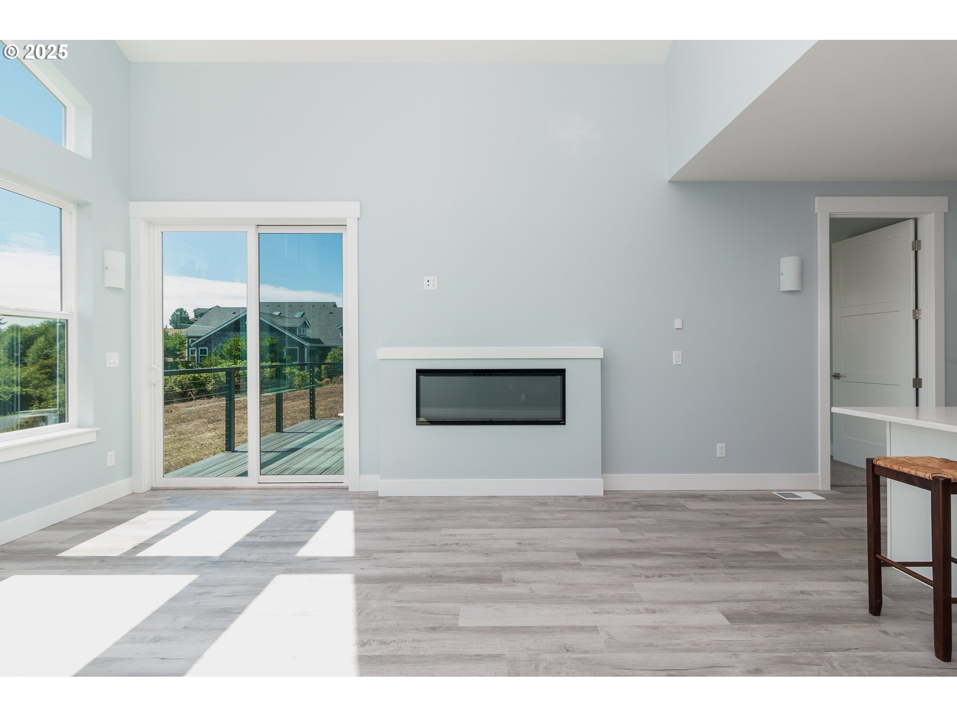 6485 Heron View Neskowin, OR 97149 - Photo 5 of 46 a view of an empty room with wooden floor and a window