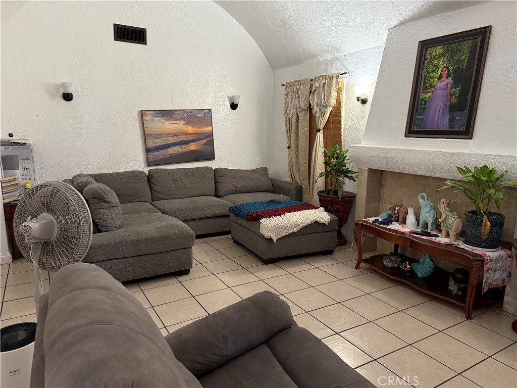 3011 South Rimpau Boulevard Los Angeles, CA 90016 - Photo 4 of 4 a living room with furniture and a couch