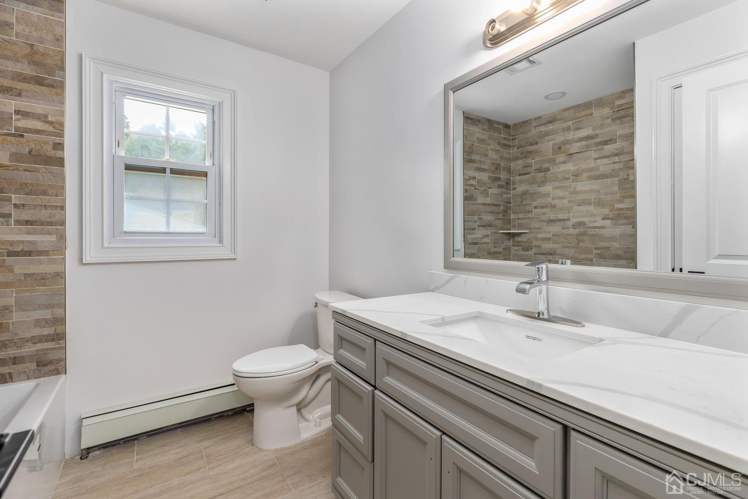 12 Annette Drive Edison, NJ 08820 - Photo 11 of 42 a bathroom with a sink toilet and mirror
