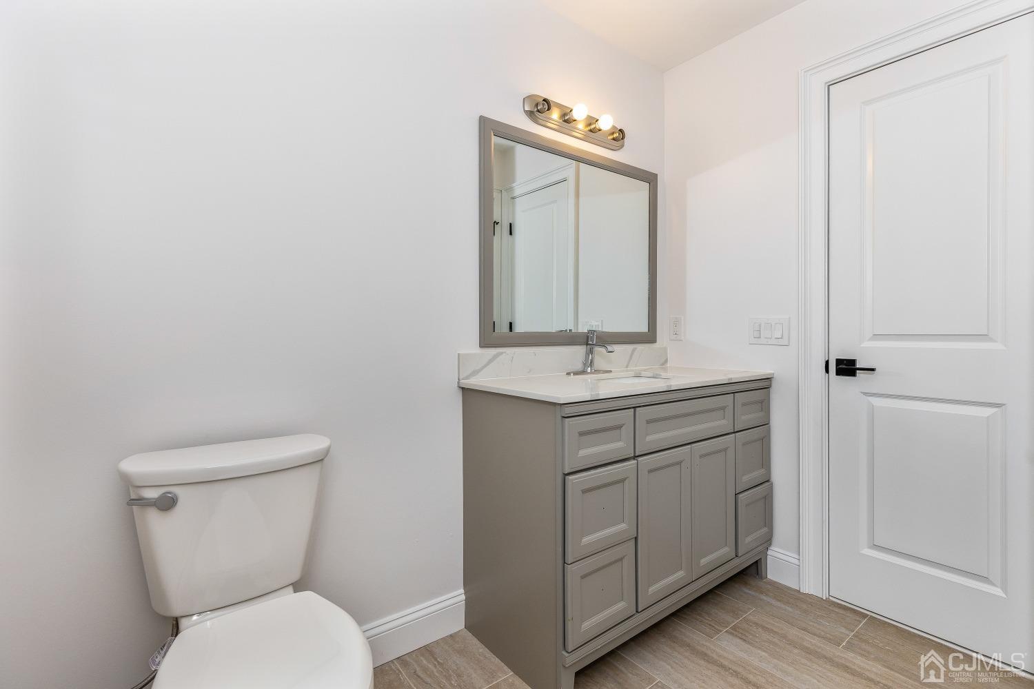 12 Annette Drive Edison, NJ 08820 - Photo 12 of 42 a bathroom with a toilet a sink and mirror