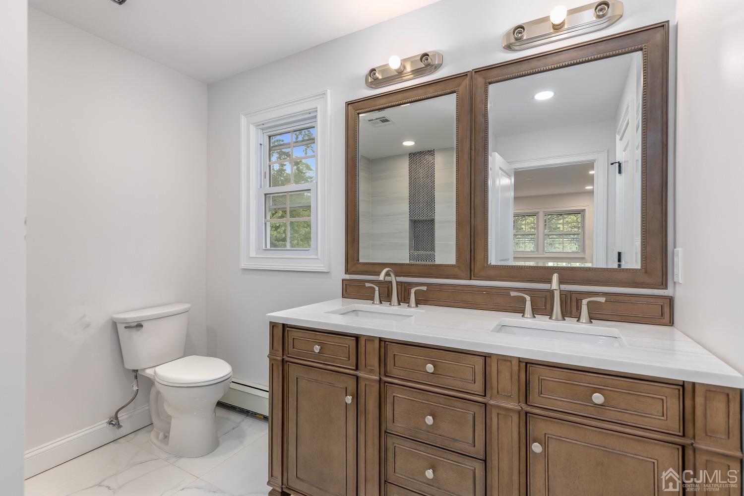 12 Annette Drive Edison, NJ 08820 - Photo 16 of 42 a bathroom with a toilet sink and mirror