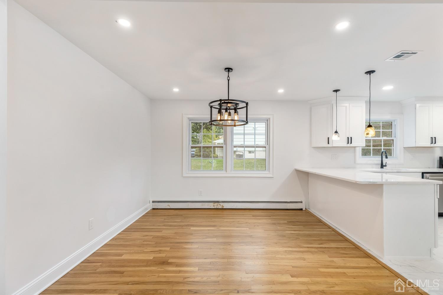 12 Annette Drive Edison, NJ 08820 - Photo 25 of 42 an empty room with wooden floor and windows
