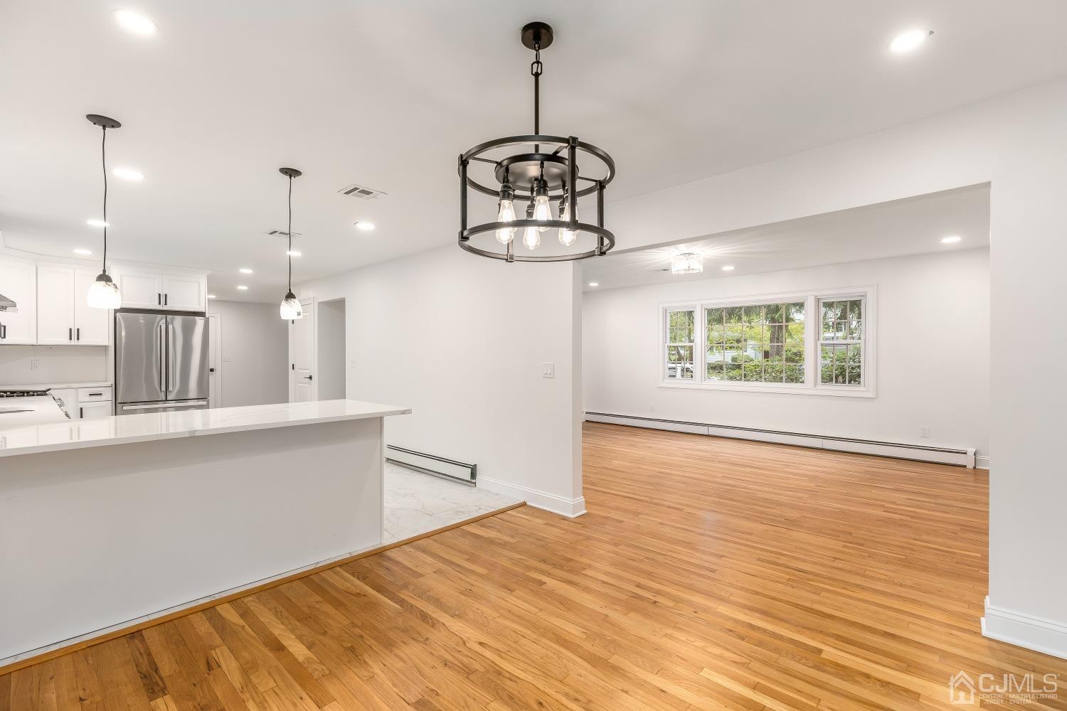 12 Annette Drive Edison, NJ 08820 - Photo 26 of 42 a view of a room with wooden floor kitchen view and a window