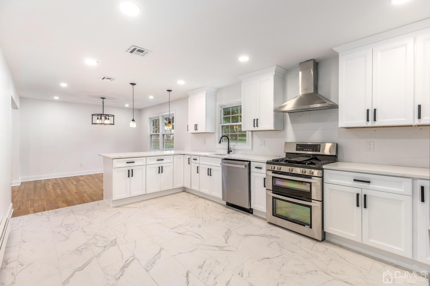 12 Annette Drive Edison, NJ 08820 - Photo 27 of 42 a large white kitchen with stainless steel appliances