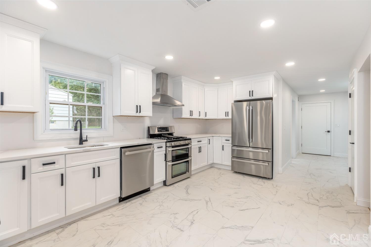 12 Annette Drive Edison, NJ 08820 - Photo 28 of 42 a kitchen with white cabinets and white appliances