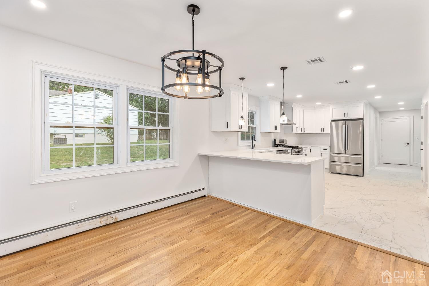 12 Annette Drive Edison, NJ 08820 - Photo 29 of 42 a view of kitchen with center island wooden floor and windows