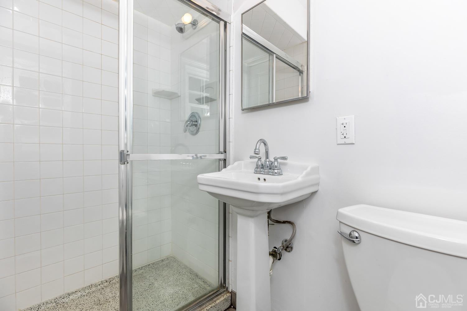 12 Annette Drive Edison, NJ 08820 - Photo 35 of 42 a bathroom with a sink a toilet and shower