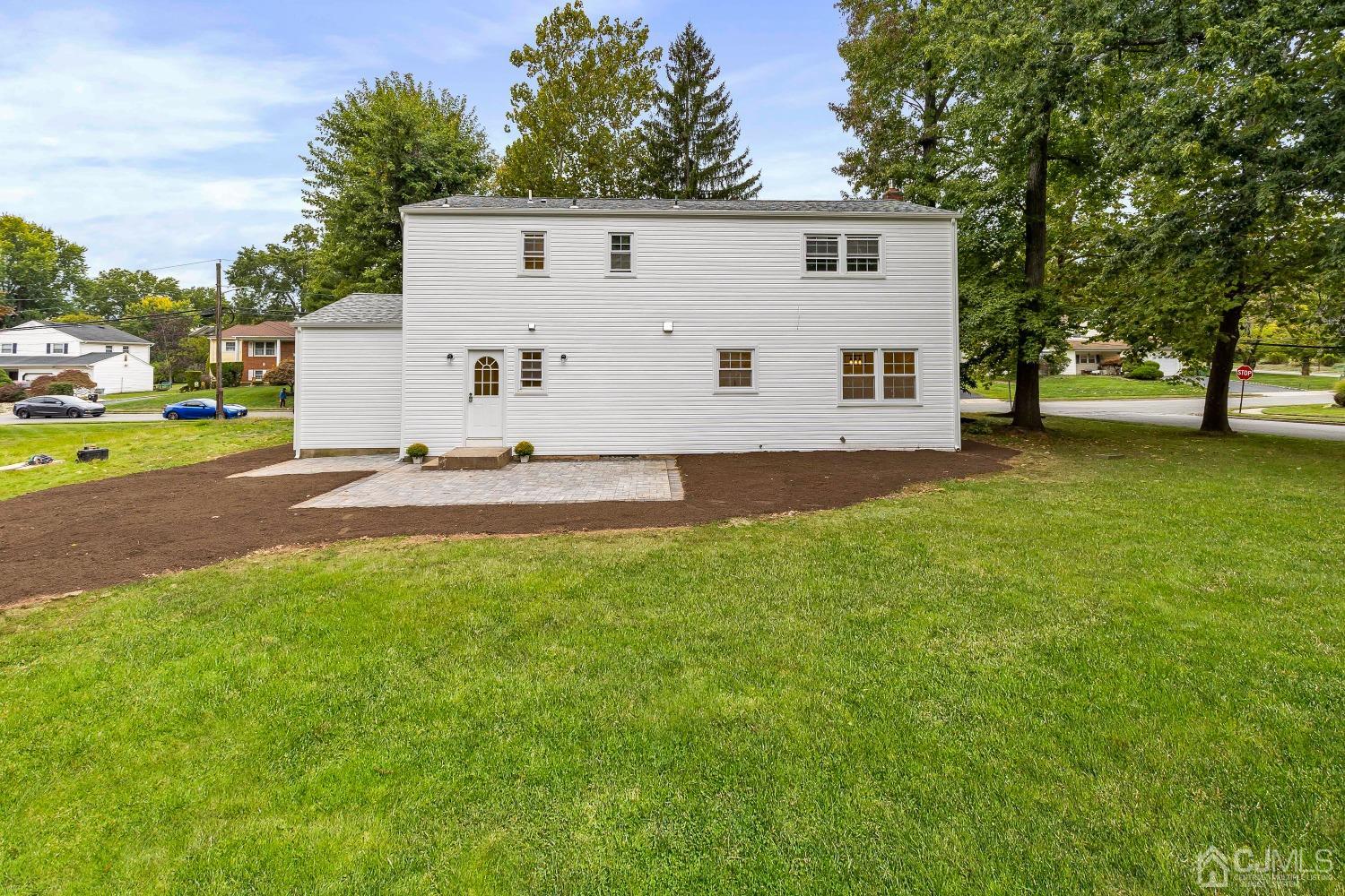 12 Annette Drive Edison, NJ 08820 - Photo 39 of 42 a view of a white house with a big yard and large trees