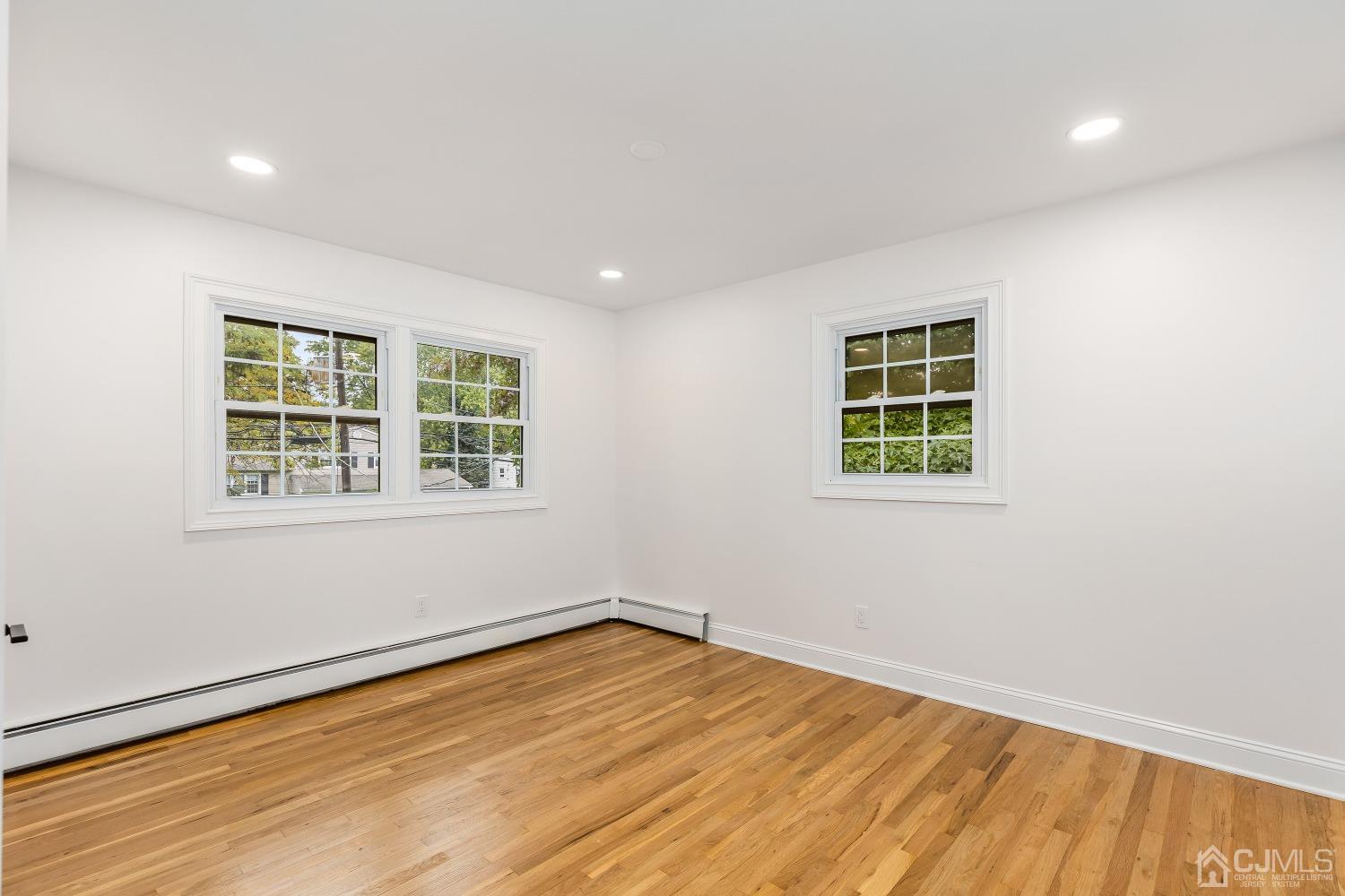 12 Annette Drive Edison, NJ 08820 - Photo 10 of 42 an empty room with wooden floor and windows