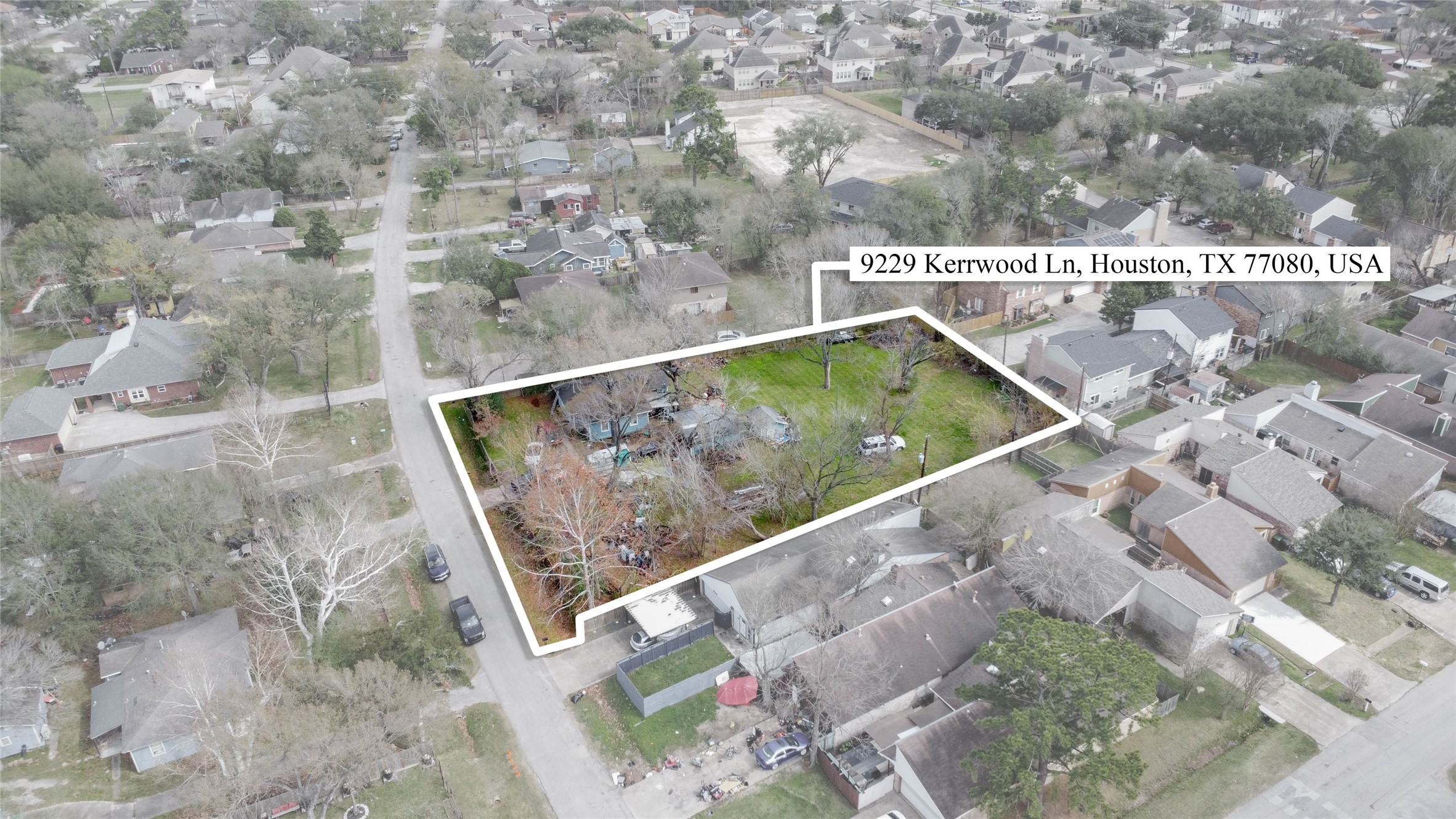 Aerial perspective showcasing the full 31,200 SF parcel outlined for clarity, highlighting its impressive width and depth within established Spring Branch Estates. Mature trees create a natural canopy across the property, while surrounding streets and neighboring homes illustrate the strong residential character of the area. This expansive footprint clearly demonstrates the potential for subdivision and future development in a prime infill location.