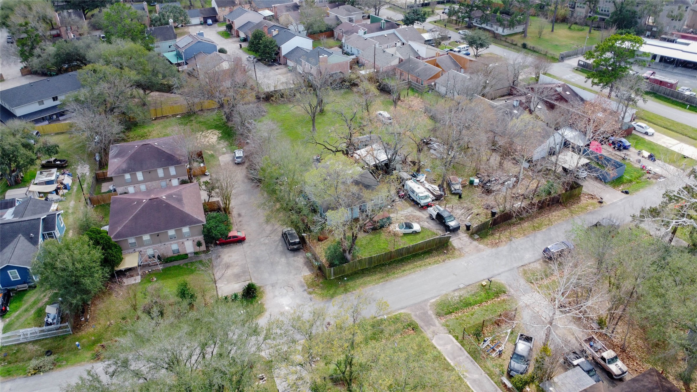 9229 Kerrwood Lane Houston, TX 77080 - Photo 5 of 12 Wide neighborhood aerial showcasing the property’s proximity to surrounding residential homes, updated builds, and ongoing area improvements. The large green expanse contrasts with neighboring lot sizes, reinforcing its rarity. This vantage point demonstrates strong infill potential within a consistently developed community near major Houston thoroughfares.