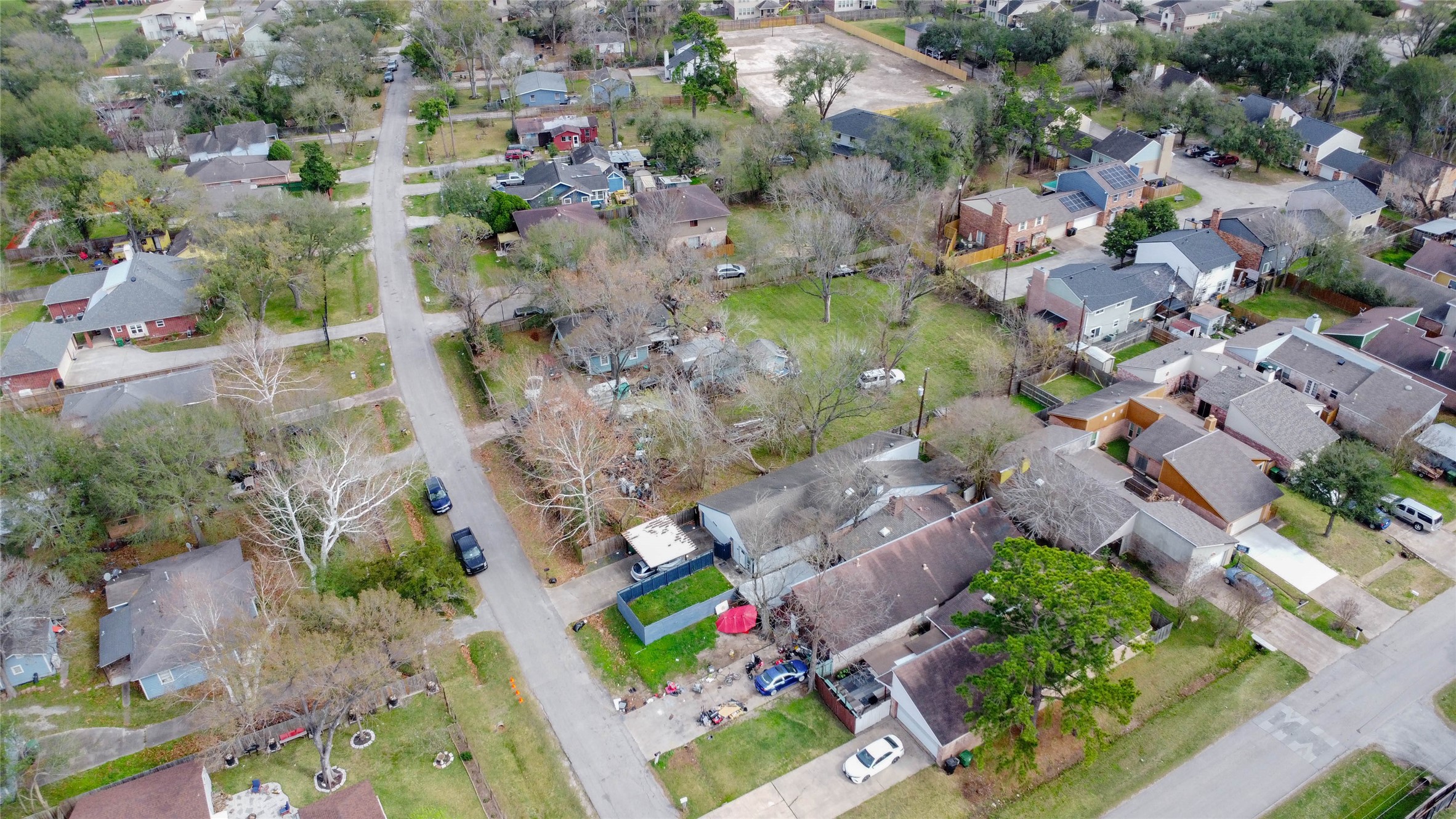 9229 Kerrwood Lane Houston, TX 77080 - Photo 6 of 12 Expanded aerial view emphasizing the property’s location within the broader Spring Branch corridor. Nearby parks, residential streets, and established homes create a stable community setting. The lot’s size and tree coverage stand out prominently, underscoring its redevelopment appeal in an area experiencing steady growth and revitalization.