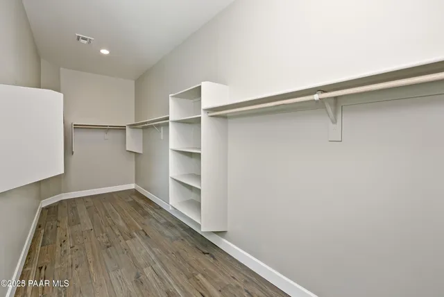 a view of walk in closet with empty racks