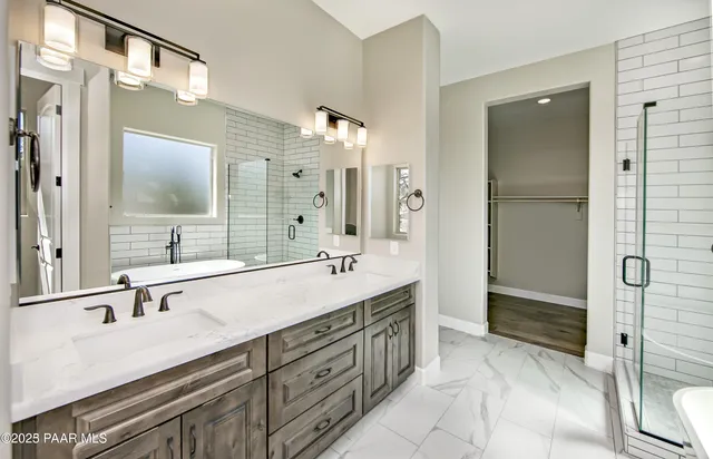 a spacious bathroom with a double vanity sink shower and mirror