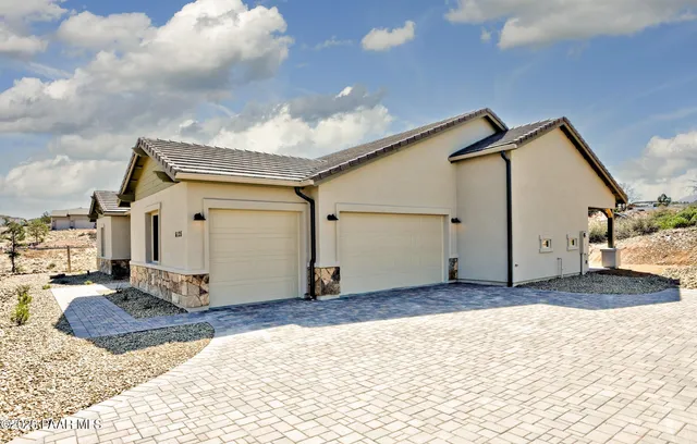 a view of a house with a snow in the background