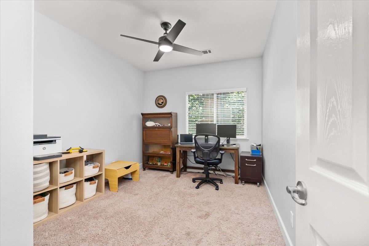 437 Silver Ridge Court Oakdale, CA 95361 - Photo 26 of 41 a view of a workspace with furniture and a window