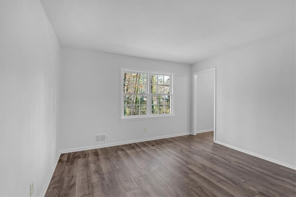 2080 Bluffton Way Decatur, GA 30035 - Photo 11 of 48 an empty room with wooden floor and windows