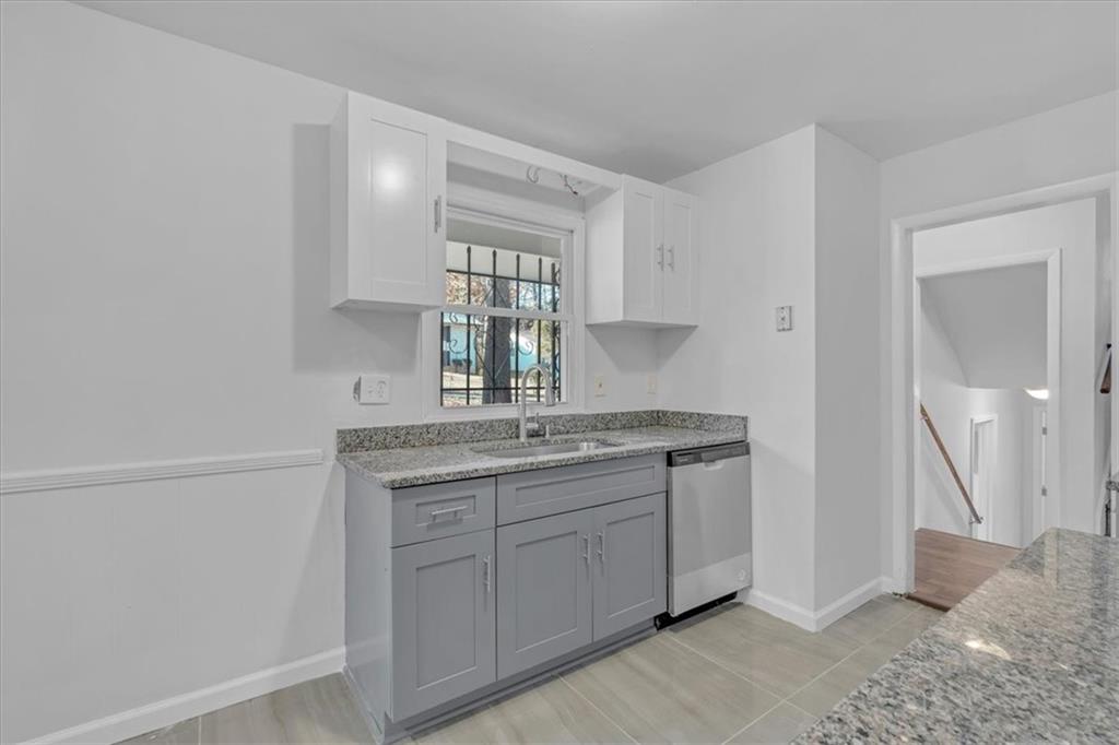 2080 Bluffton Way Decatur, GA 30035 - Photo 17 of 48 a bathroom with a granite countertop sink a mirror and a window