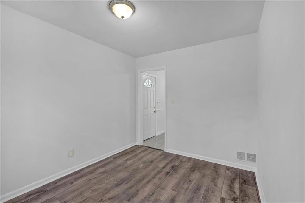 2080 Bluffton Way Decatur, GA 30035 - Photo 20 of 48 a view of an empty room with wooden floor and a window