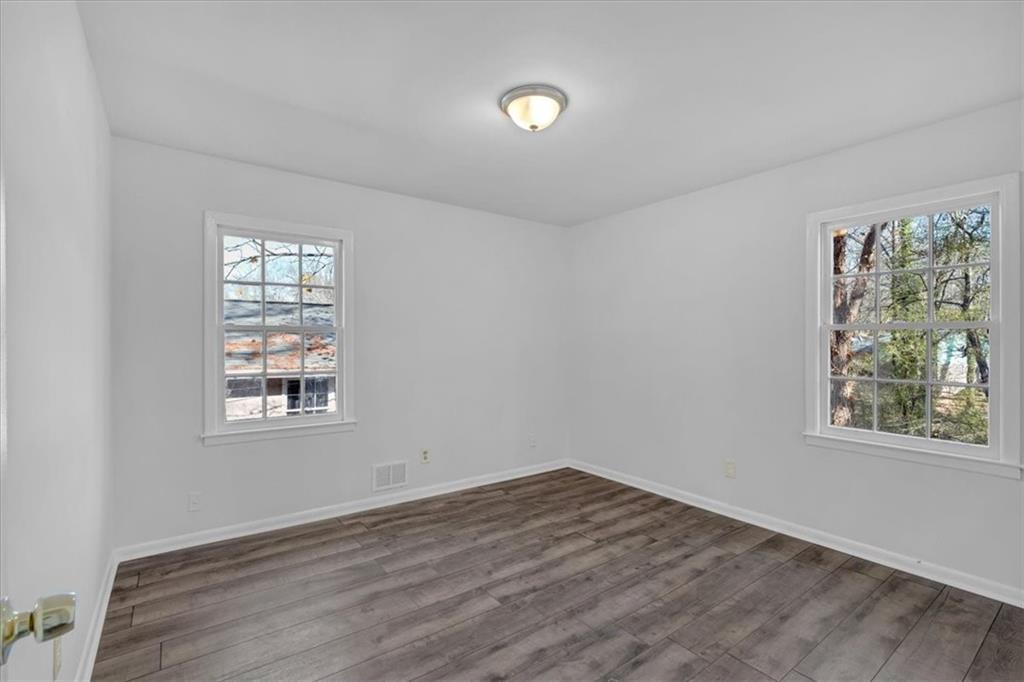 2080 Bluffton Way Decatur, GA 30035 - Photo 23 of 48 a view of an empty room with wooden floor and a window