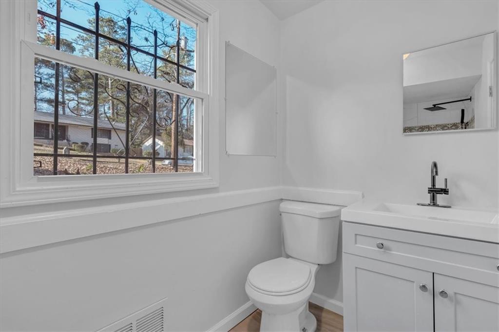 2080 Bluffton Way Decatur, GA 30035 - Photo 32 of 48 a bathroom with a toilet a sink and a window
