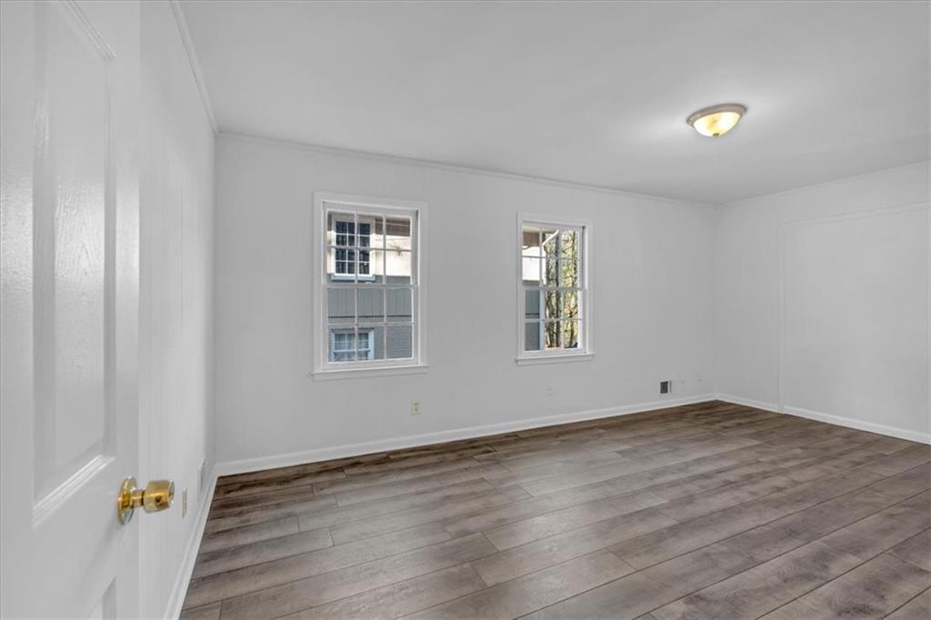 2080 Bluffton Way Decatur, GA 30035 - Photo 35 of 48 an empty room with wooden floor and windows