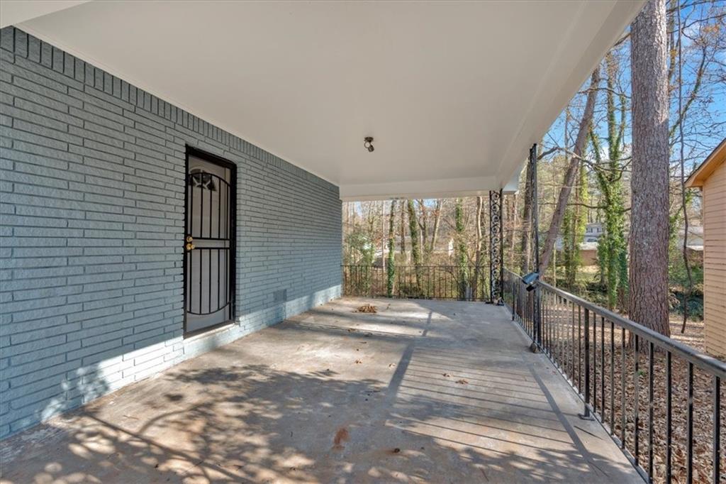 2080 Bluffton Way Decatur, GA 30035 - Photo 6 of 48 a view of a porch with wooden floor and iron stairs
